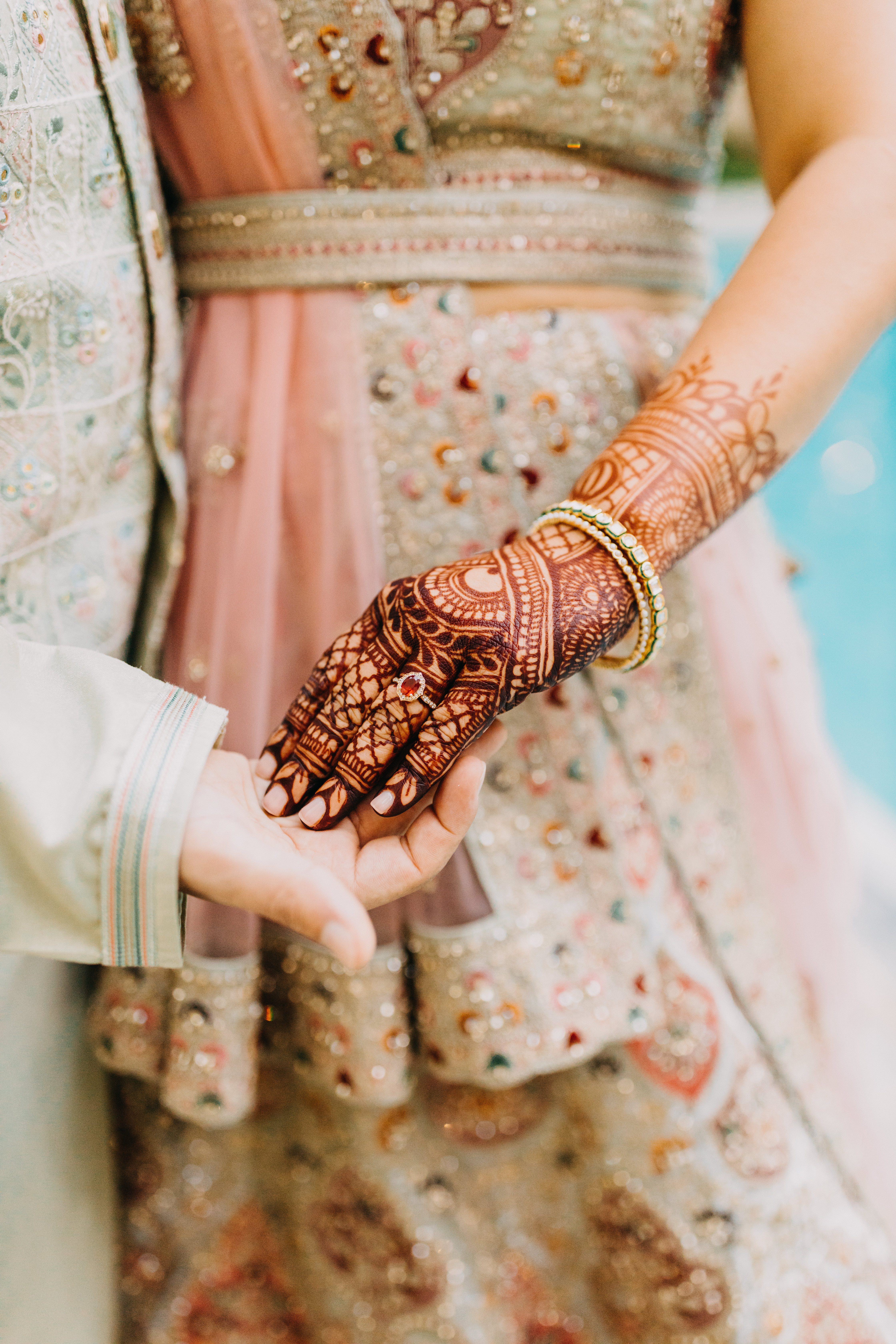 A gorgeous bride donned in henna across her arms.